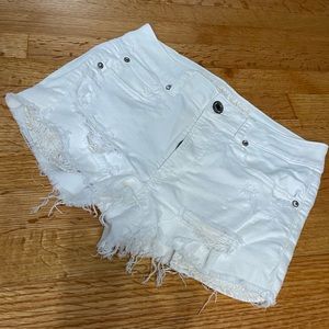 White stretch ripped jeans shorts.